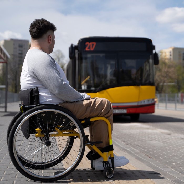 Disabled man in wheelchair waiting for bus