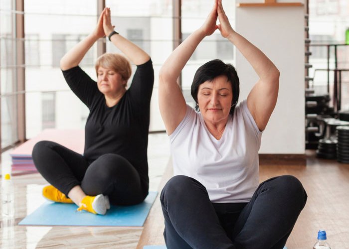 Two woman doing yoga